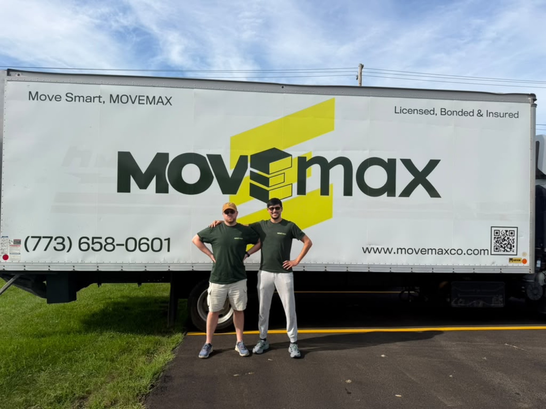 Two MoveMax movers in front of the MoveMax truck